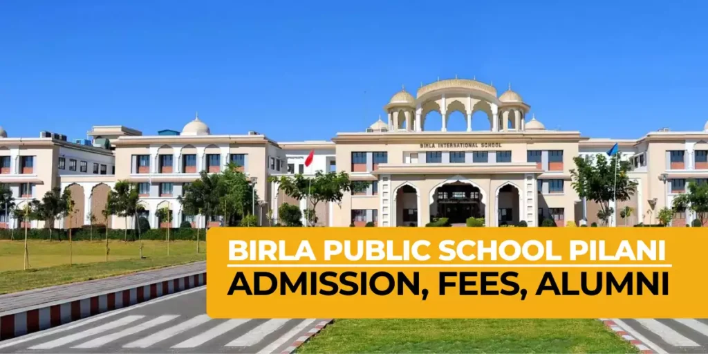 This image is a bright promotional banner for Birla Public School Pilani, featuring a stunning wide-angle view of the expansive, modern campus building set against a clear blue sky. The grand cream-coloured structure showcases elegant golden domes, arched windows, ornate pillars, and a central entrance portico with the name “BIRLA INTERNATIONAL SCHOOL” displayed prominently on the facade. In the foreground, a paved road with a zebra crossing is bordered by lush green lawns, neatly planted young trees, and flagpoles, one bearing the Indian flag. A large yellow overlay banner at the bottom boldly states “BIRLA PUBLIC SCHOOL PILANI ADMISSION, FEES, ALUMNI” in white and black lettering, highlighting essential information for admissions.